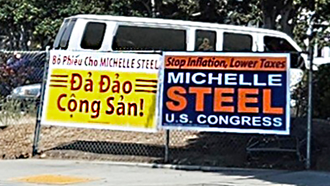 Signs supporting Rep. Michelle Steel. The sign on the left, in Vietnamese, reads, "Vote For Michelle Steel, Down With Communism."