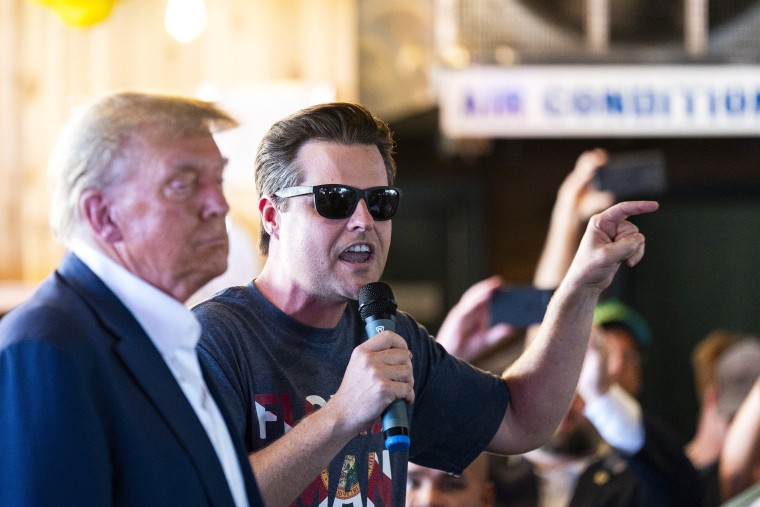 Representative Matt Gaetz, Republican from Florida, speaks with former President Donald Trump, 2024 Republican presidential candidate, left, at the Steer N' Stein bar while attending the Iowa State Fair in Des Moines, Iowa, US, on Saturday, Aug. 12, 2023. Republican presidential hopefuls are crowding into Des Moines this weekend, hoping to make enough of an impression that voters will remember them come the Jan. 15 party caucuses.