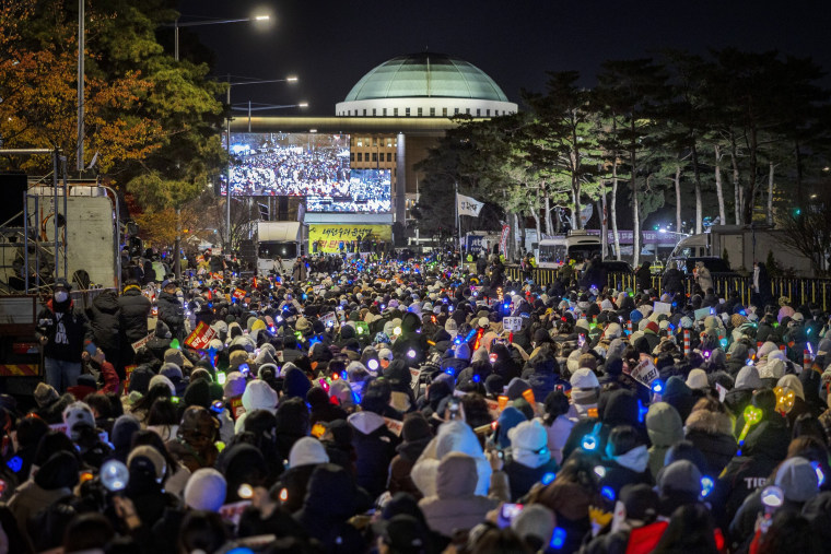 Protesters they take part in a protest against the president outside the National Assembly in Seoul, South Korea. 