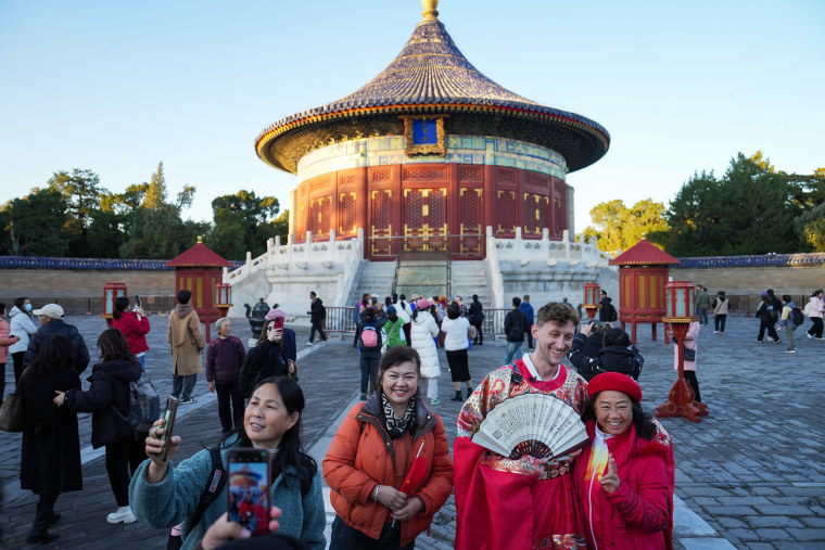 Tourists pose for photos at Heaven Park in Beijing on Nov. 21, 2024. 