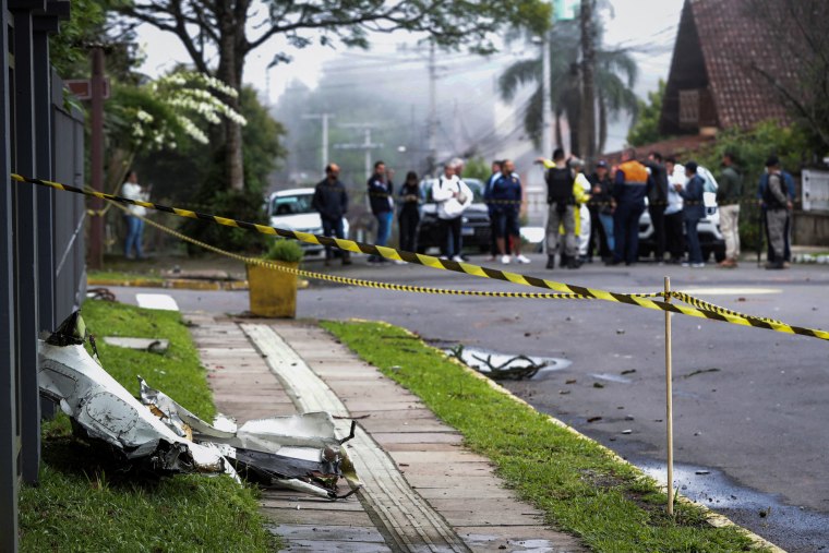 A piece of plane debris on a sidewalk sectioned off with caution tape