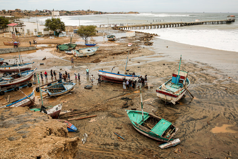 Fishing boats are seen stranded by strong waves