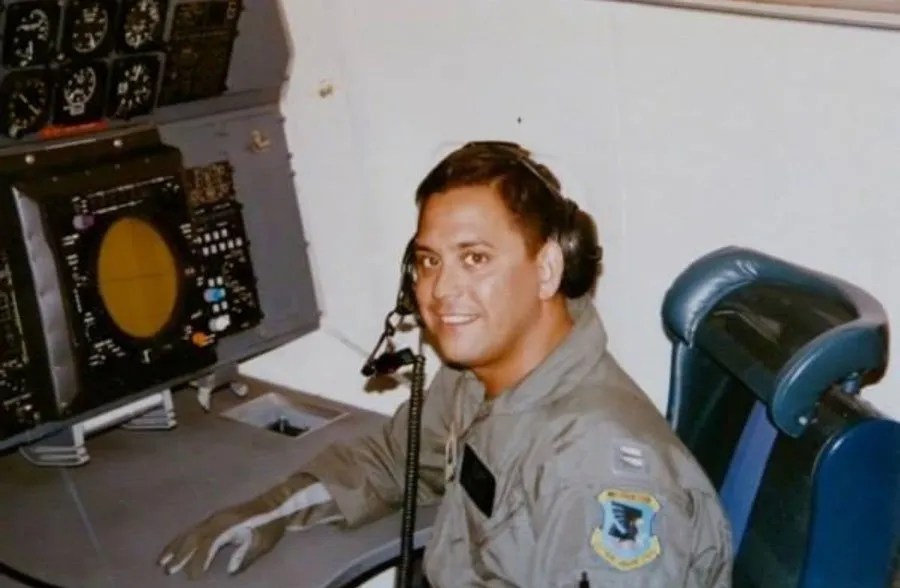 Andrew Espinosa at a desk in Air Force uniform