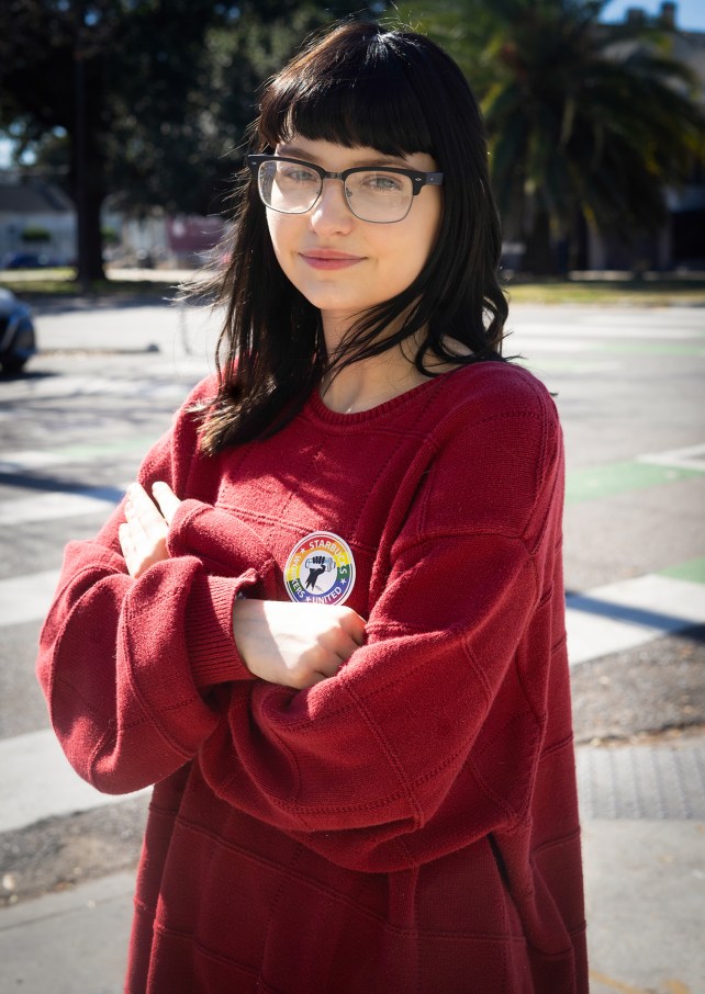 Portrait of a woman in glasses with her arms crossed.