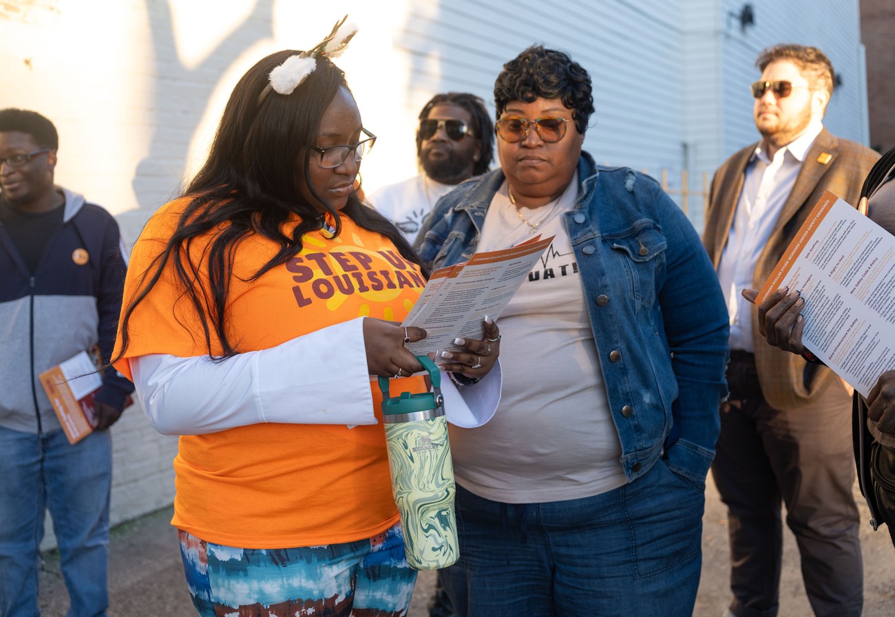 Two woman reading a pamphlet.