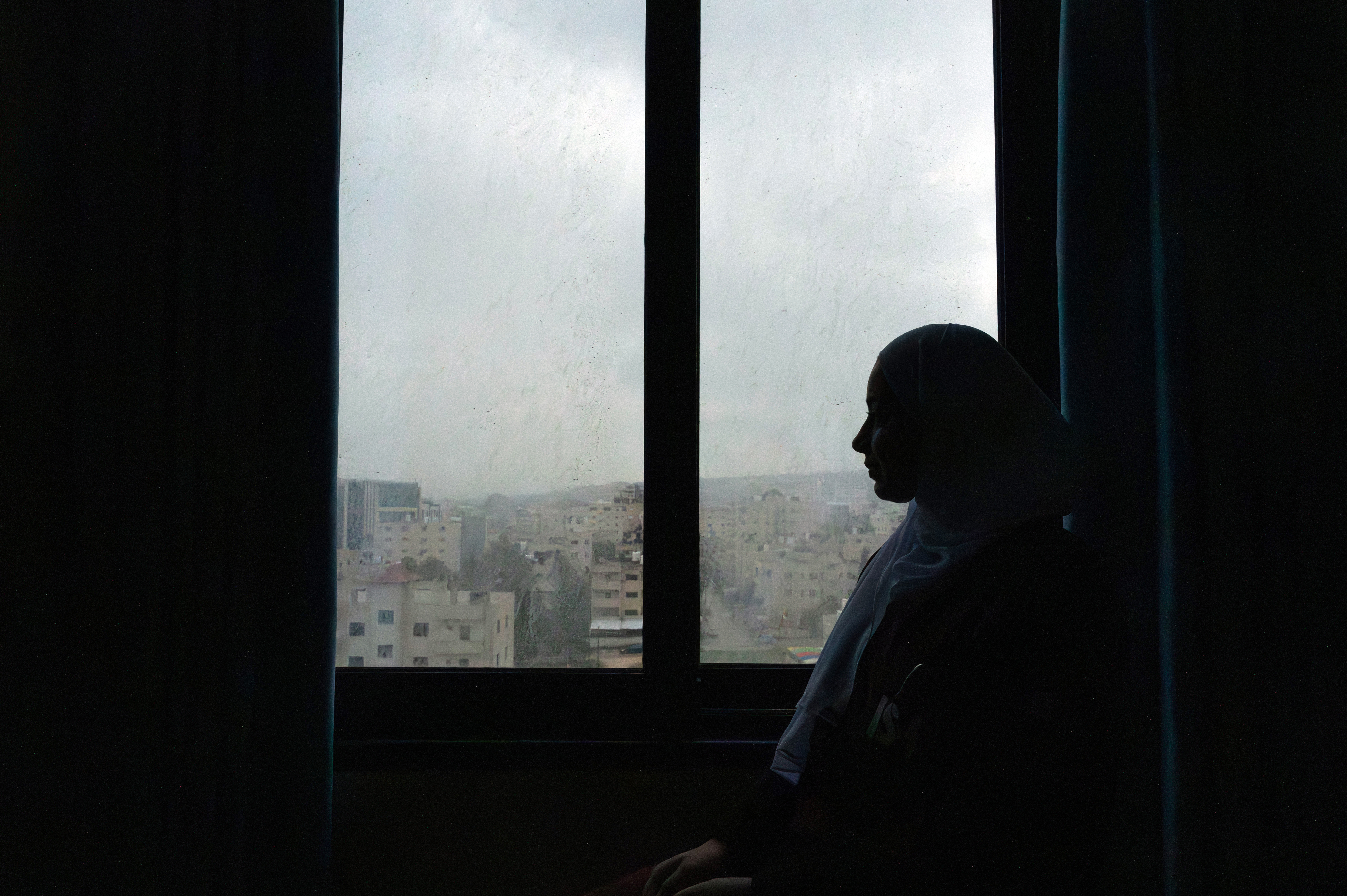 Woman sitting by a window.