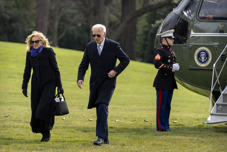 President Joe Biden and first lady Jill Biden walk across the South Lawn of the White House