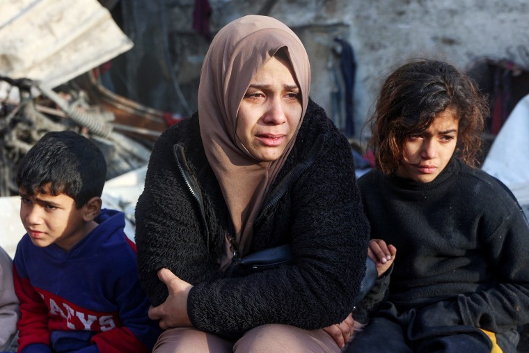 A woman cries as she watches the destruction in the aftermath of an Israeli strike at the Al-Farabi school in the centre of Gaza City, which is sheltering a number of displaced people, on January 15, 2025, amid the ongoing war between Israel and the militant group Hamas. 