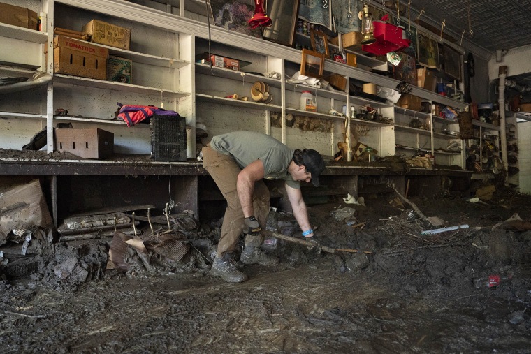 Volunteers shovel debris and mud out of Whitson Furniture and General Store in Green Mountain, N.C., on Oct. 6, 2024, in the aftermath of Hurricane Helene. Whitson Furniture and General Store is a 64-year-old small family business.