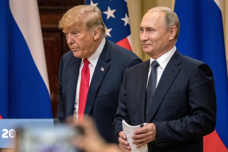 Image: President Donald Trump and Russian President Vladimir Putin arrive to waiting media during a joint press conference after their summit