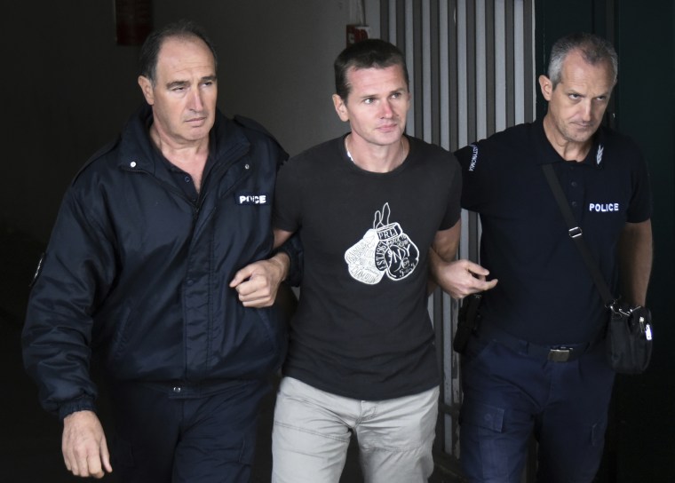 Alexander Vinnik is escorted from a courthouse in Thessaloniki, Greece, in 2017. 