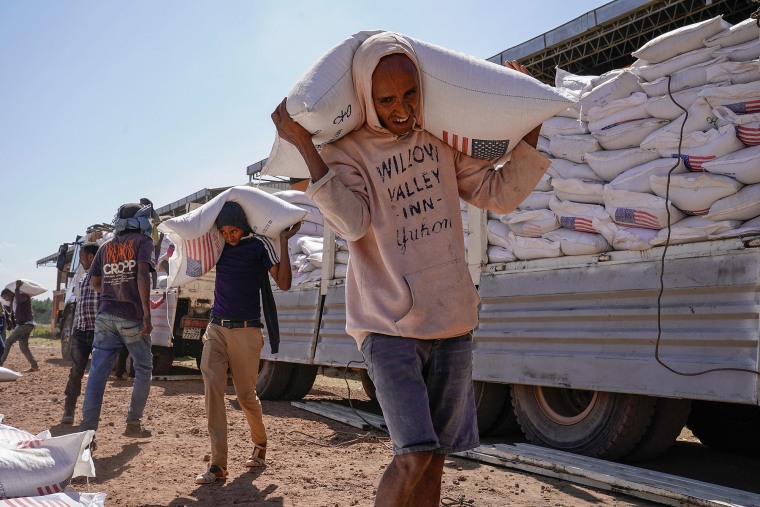 Volunteers at displacement camp unload an aid delivery from USAID on Dec. 17, 2021 in Bahir Dar, Ethiopia. 