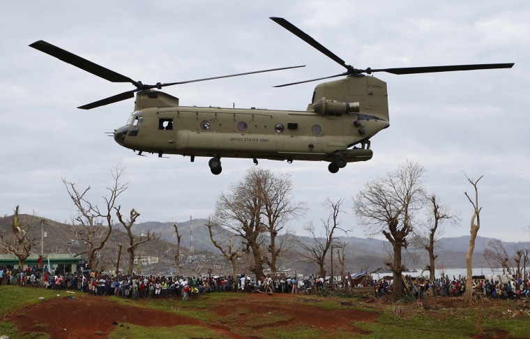 A U.S. military helicopter takes off after dropping off USAID relief supplies in Haiti