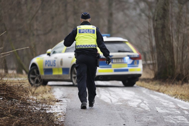 A police officers walks towards a police vehicle near the Risbergska School in Orebro, Sweden, on Feb. 4, 2025, following reports of a serious violent crime. 