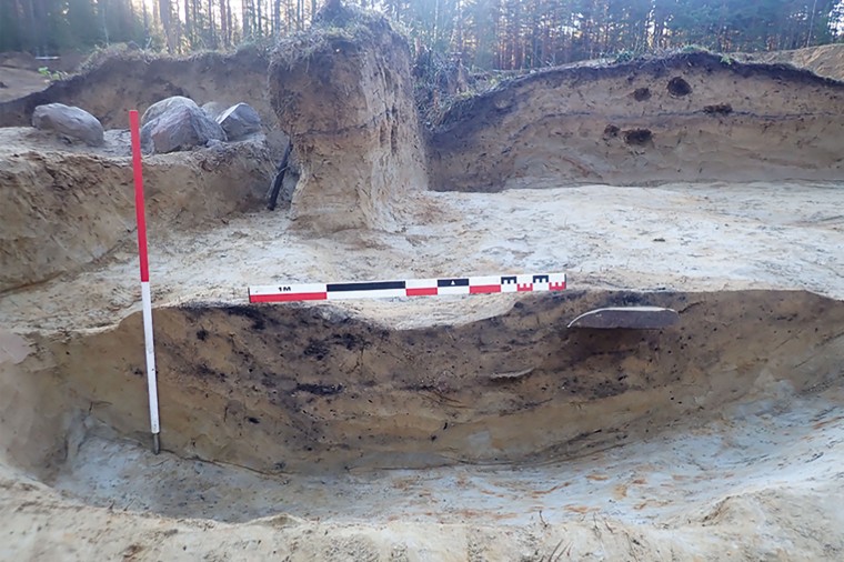 The runic stone is visible in a section of excavations. 