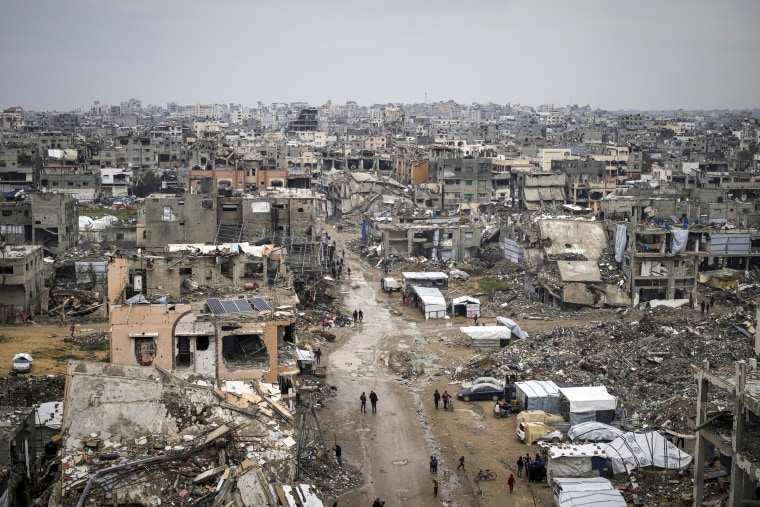 People walk around the debris.