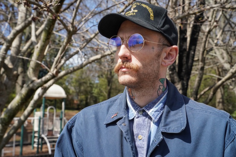 John Wippler stands outside for a portrait in a park