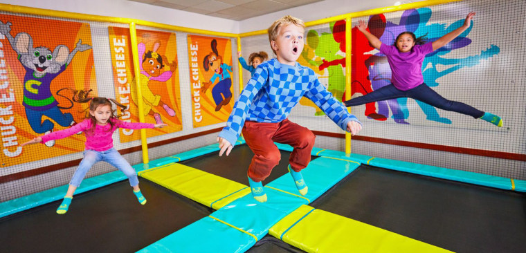 Children jump on a trampoline at Chuck E. Cheese.