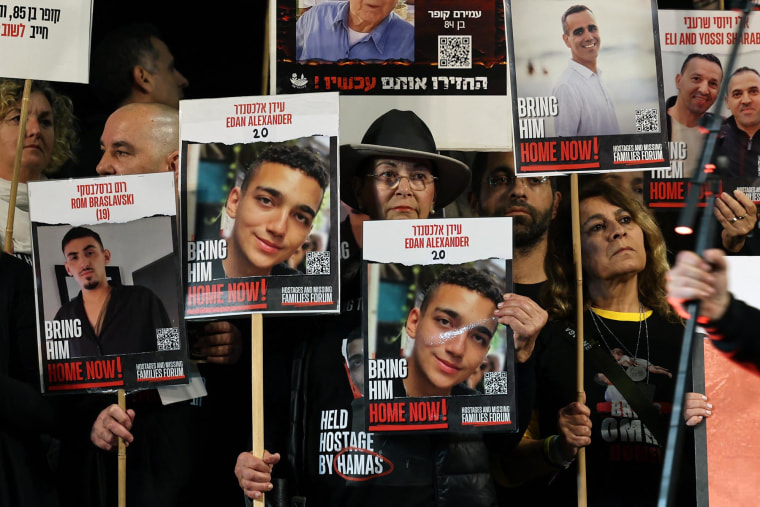 Relatives and supporters hold placards of Israeli hostages, including Edan Alexander, in Tel Aviv on Dec. 30, 2023. 